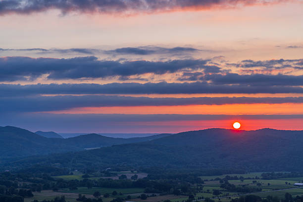 istock Colorful sunset over rolling hills creating a beautiful landscape 2218428302