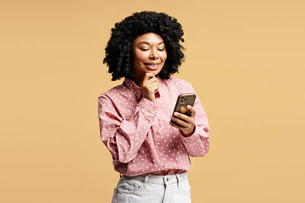 istock Young woman using smartphone and thinking about something 2218428635