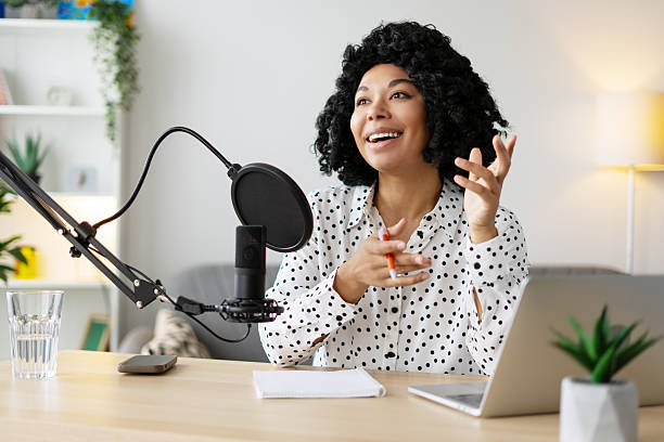 istock Young woman recording a podcast from her home studio 2218428676