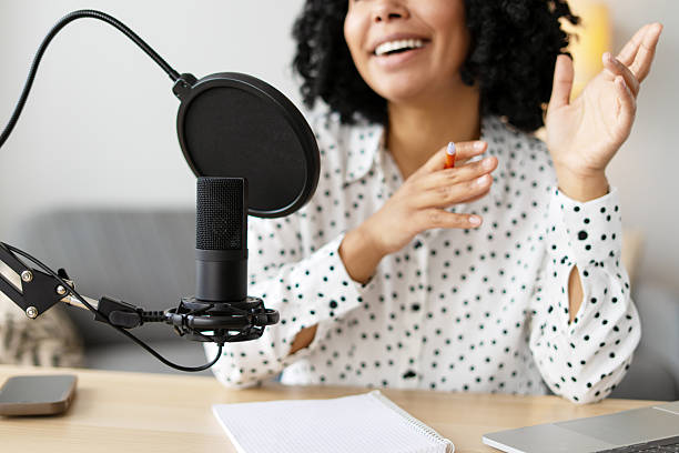 istock Young woman recording a podcast from her home studio 2218428697