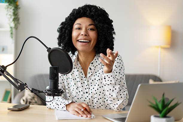 istock Young woman recording a podcast from her home studio 2218428707