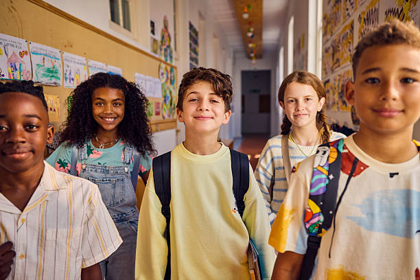 istock Portrait of elementary school student carrying backpack in school hallway 2218430963