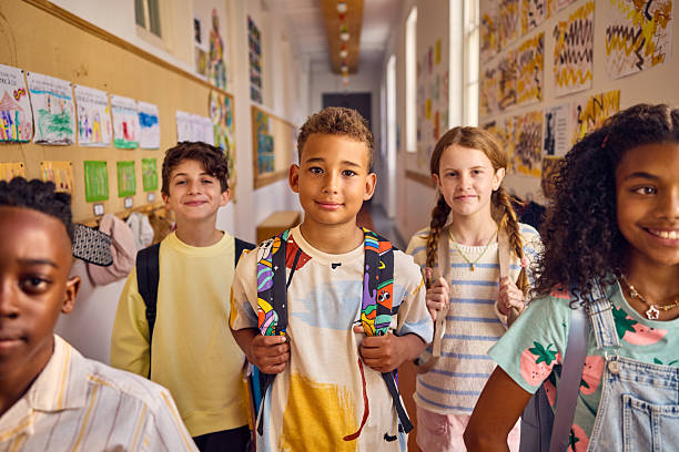 istock Diverse group of elementary age students smiling in school hallway 2218430966