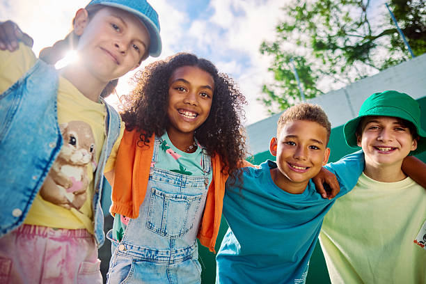 istock Group of elementary age students smiling together at school 2218430980