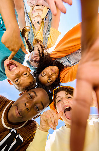 istock Group of children making funny faces in a circle 2218431023