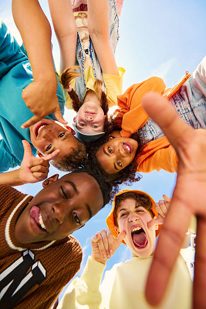 istock Group of children making funny faces in a circle 2218431035