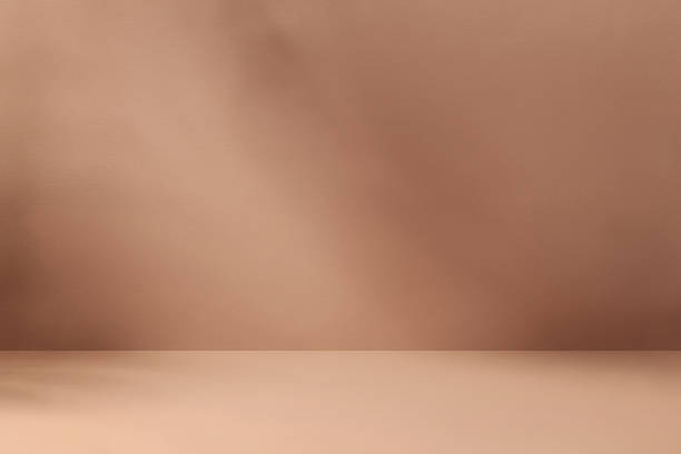 Minimalistic abstract mocha mousse color background for product presentation with aesthetic light and shadows