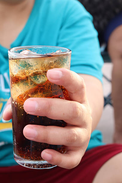 istock Woman drinking cola on hand 2218433514