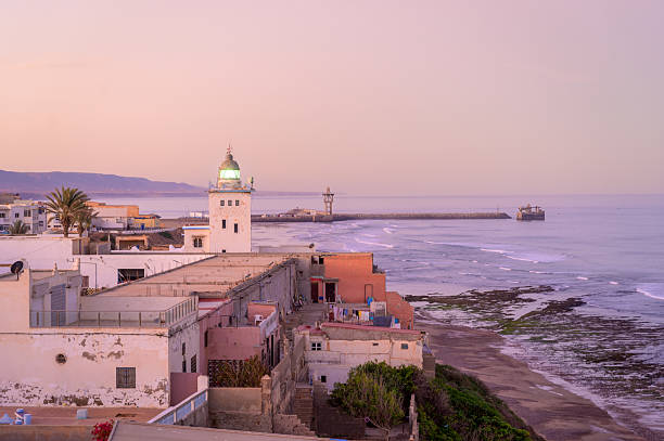 istock Sunset view over Sidi Ifni coast with lighthouse and waterfront buildings in Morocco 2218433891