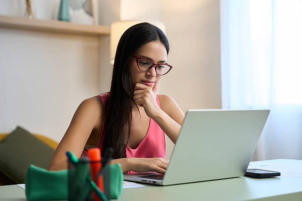 istock Focused young woman working from home on laptop 2218434539