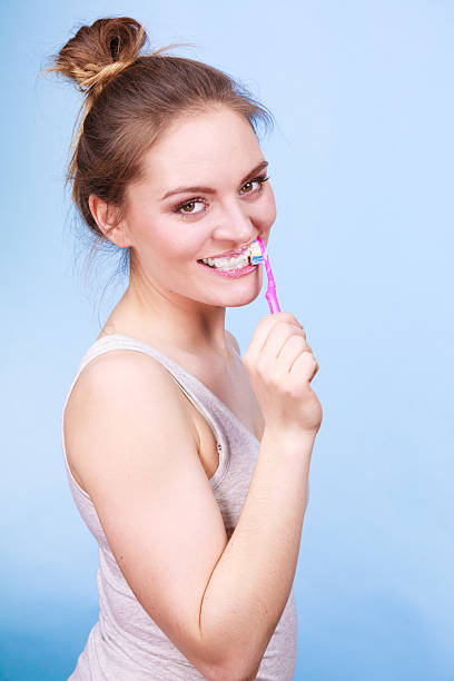istock Woman brushing cleaning teeth 2218435435