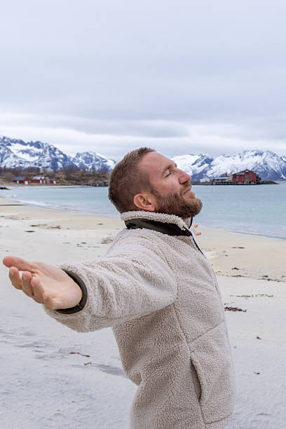 istock Man Enjoying Peaceful Beach with Mountain View 2218435654
