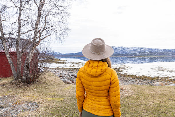 istock Woman in Hat Walking by Scenic Waterside in Spring 2218436209