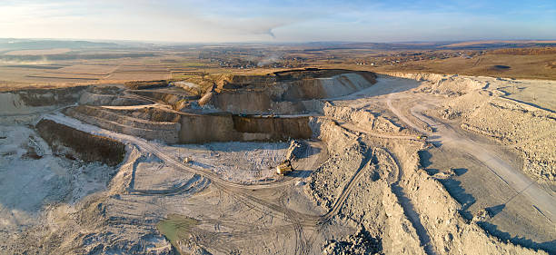 istock Aerial view of open pit mining site of limestone materials for construction industry with excavators and dump trucks 2218437709