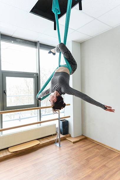 istock Graceful woman upside down in aerial silk backbend pose. 2218439446