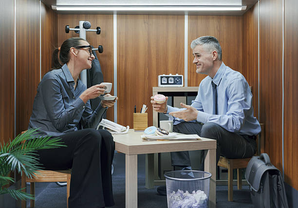 A young business woman enjoys working with her elderly female colleague in a pleasant atmosphere at workplace. Business, office, job