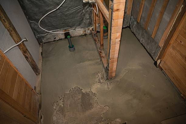 istock Freshly poured concrete floor in unfinished bathroom interior under renovation 2218440173