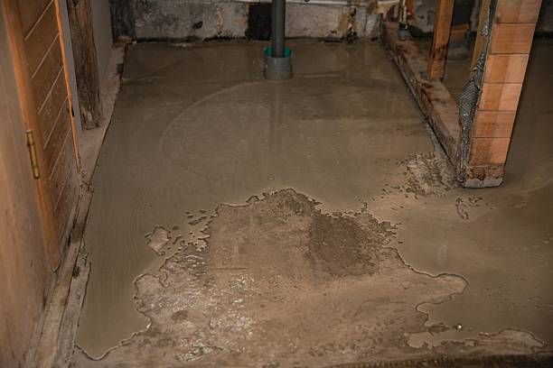 istock Freshly poured concrete floor in unfinished bathroom interior under renovation 2218440175