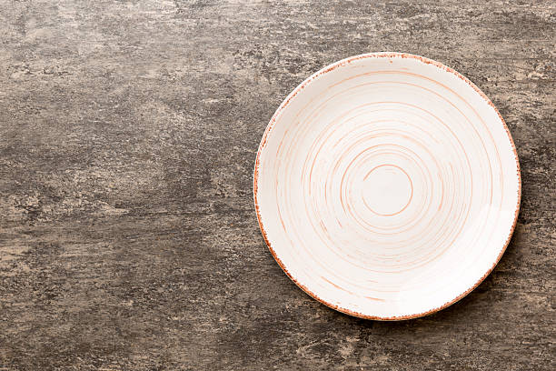 istock Top view of empty light plate on cement background. Empty space for your design 2218440204