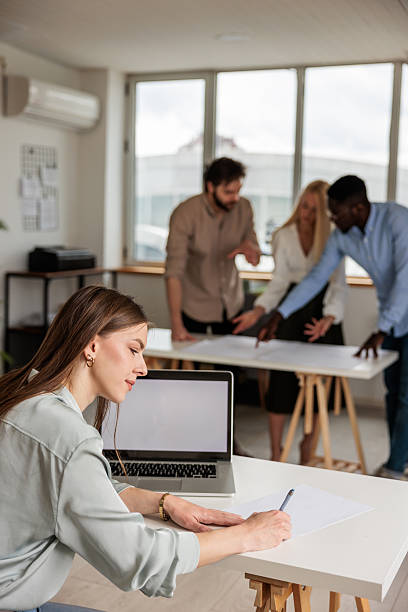 istock A young woman working at the busy office 2218441878