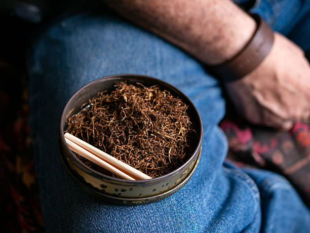 istock Preparing rolled cigarettes with dried tobacco. 2218442552