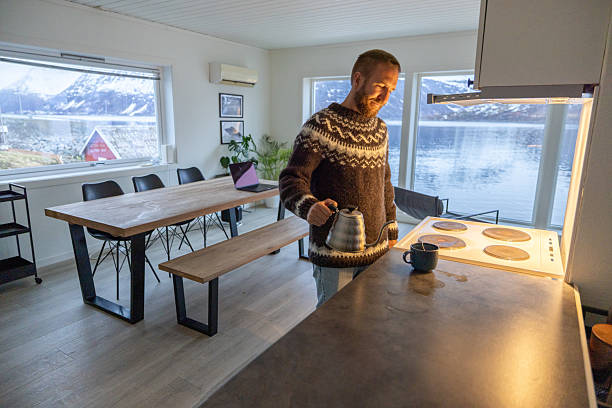 Man Preparing Coffee in Cozy Lakeside Cabin Kitchen