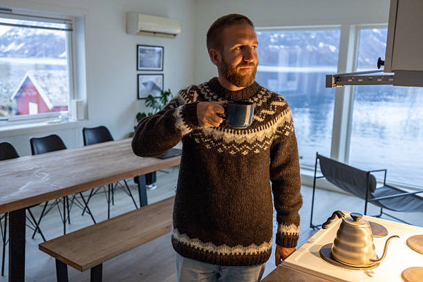 Man Enjoying Hot Drink in Cozy Winter Cabin