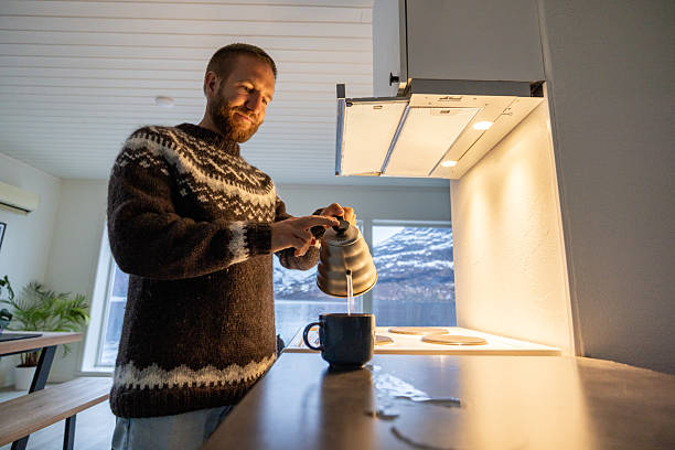 Solo male preparing himself a hot drink in the morning, Norwegian lifestyle