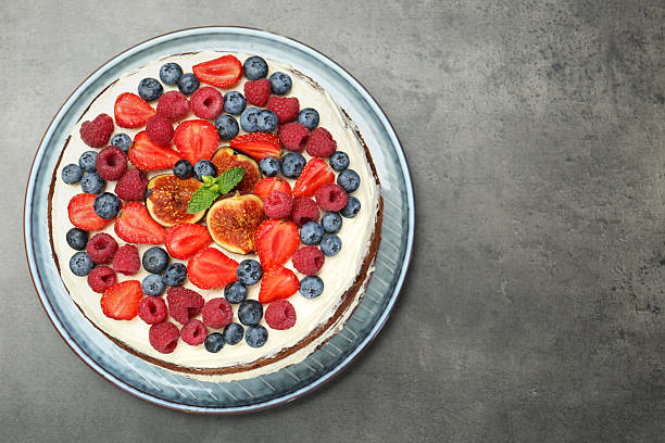 istock Delicious chocolate sponge cake with berries on grey table, top view. Space for text 2218443573