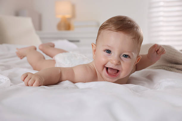 istock Cute little baby on bed at home 2218443656