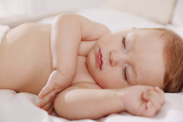istock Cute little baby sleeping on bed at home 2218443659