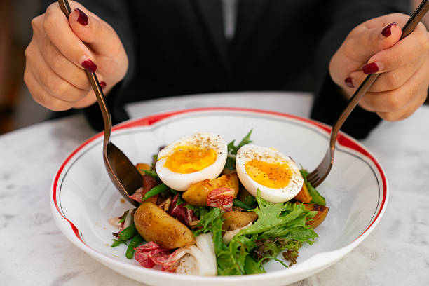 istock Woman Enjoying Healthy Salad with Soft-Boiled Eggs 2218449714