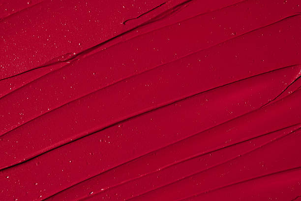 Rich red lipstick texture with smooth application and glossy finish  for beauty and cosmetic themes. Red lipstick background.