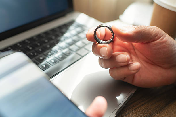 istock Man with smart ring and smartphone indoors 2218451535