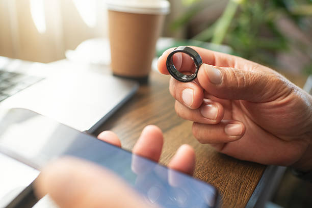 istock Man with smart ring and smartphone indoors 2218451614