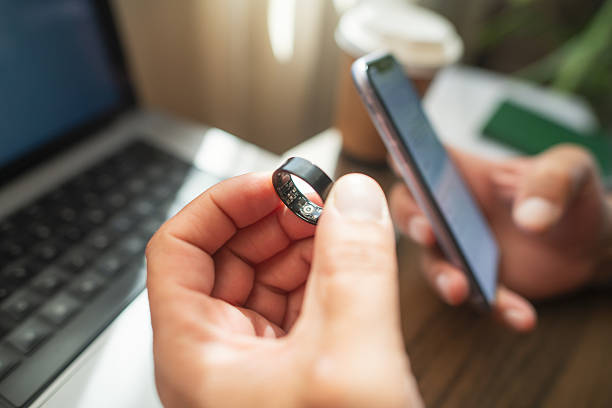 istock Man with smart ring and smartphone indoors 2218451694