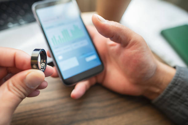 istock Man with smart ring and smartphone indoors 2218451704