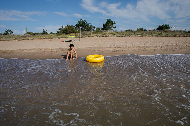 Child with inflatable doughnut in the sea