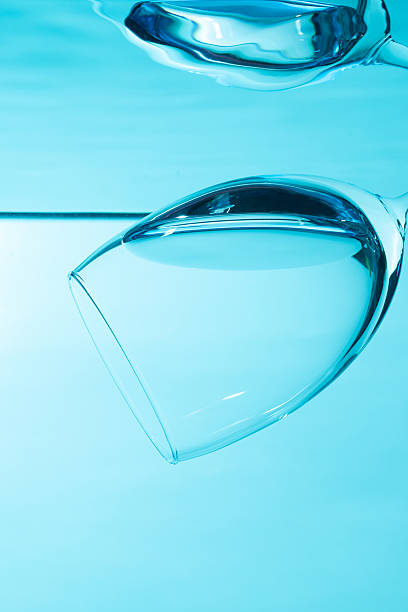 Glass in water  isolated on blue background.