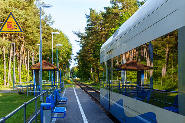 istock A modern train waits at a charming rural train station during the daytime reflecting the trees and the station's blue benches offering a peaceful transportation scene in nature 2218453949