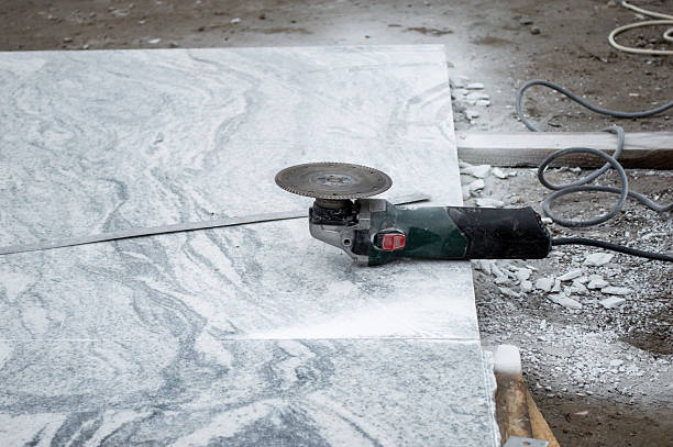 istock A power tool is actively cutting a marble slab on a construction site, surrounded by dust and debris during daylight hours 2218460296