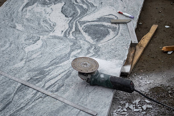 istock A granite slab sits on the ground as a cutting tool is positioned nearby on a construction site during early morning hours 2218460316