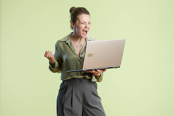 istock Celebrating success with laptop in studio 2218460789