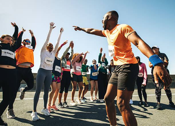 istock Dynamic running club with coach energizing the group 2218462500