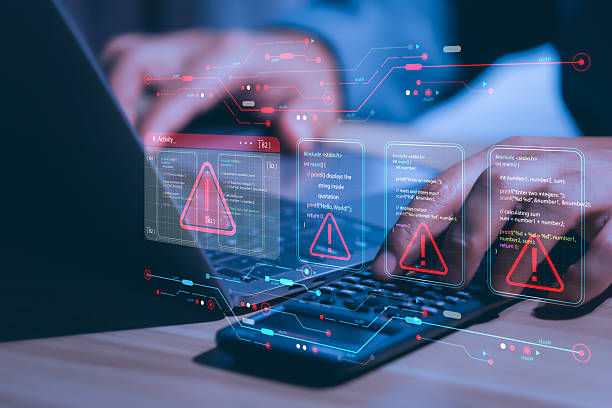 istock Businessman working on laptop computer at office with exclamation alarm caution warning notification mark sign, computer virus detected, personal data protection, network security concept 2218462876