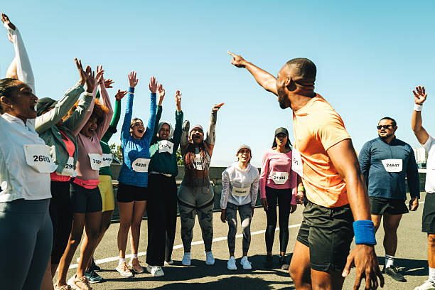 istock Group of runners cheering and celebrating at a community event 2218462884