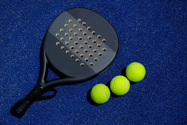 istock Padel Racket and Balls on Blue Court 2218463110