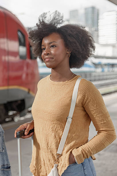 istock Couple having fun using smartphone while waiting for a train at railway station 2218463199