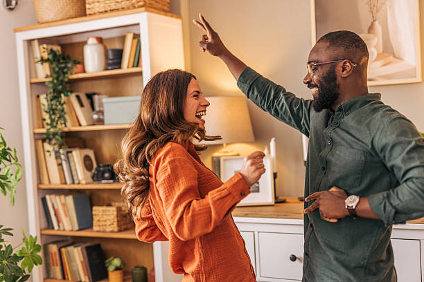 istock Happy couple dancing together and having fun at home 2218463421