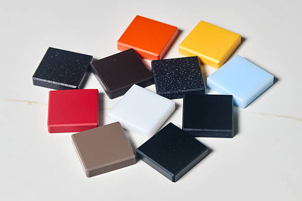 istock Porcelain stoneware artificial stone square samples as kitchen countertop examples of future kitchen facade exterior. Samples slabs of natural granite marble quartz for stone countertops close up. 2218464259